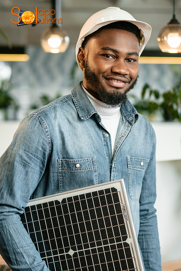Solar technician holding a solar panel